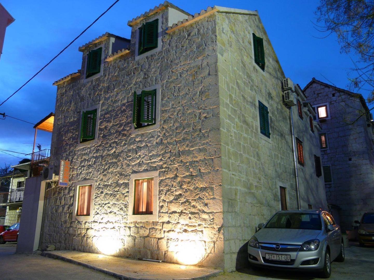 The old stone house of House Sandra lit up at dusk